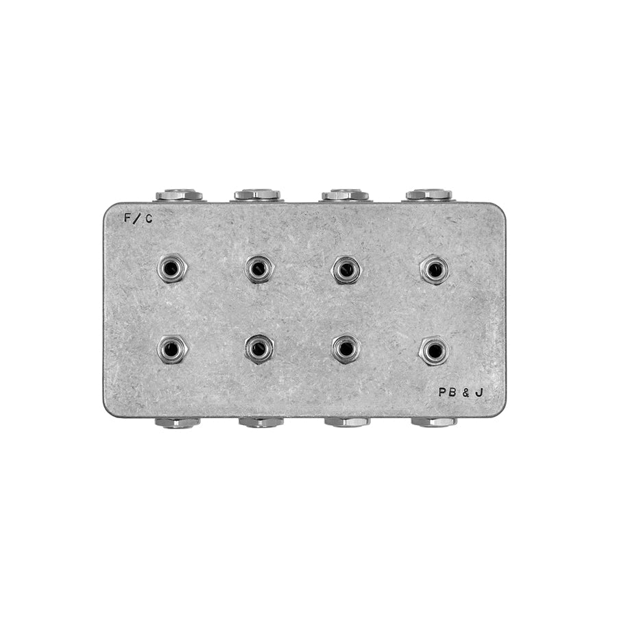 Gray metal box with eight 1/4 inch audio jack ports labeled F/C and PB & J.