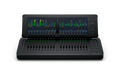 Black audio mixing console with two display screens showing level meters and multiple faders, knobs, and buttons.