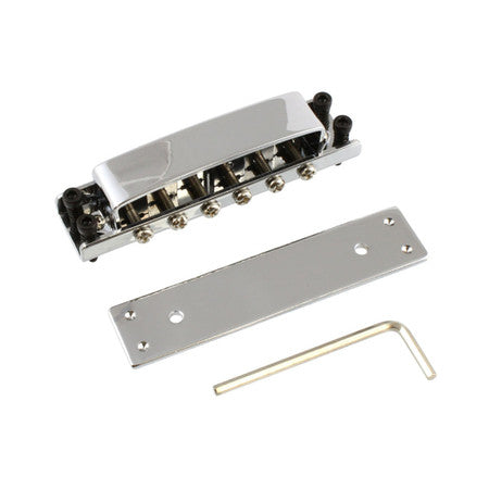 Chrome metal tune-o-matic bridge set with base plate and allen wrench on white background