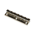 A silver metal guitar tailpiece with six string slots and three mounting holes.