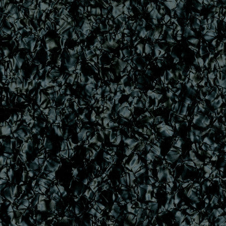 Close-up view of a black pearloid textured surface with a crumpled pattern.