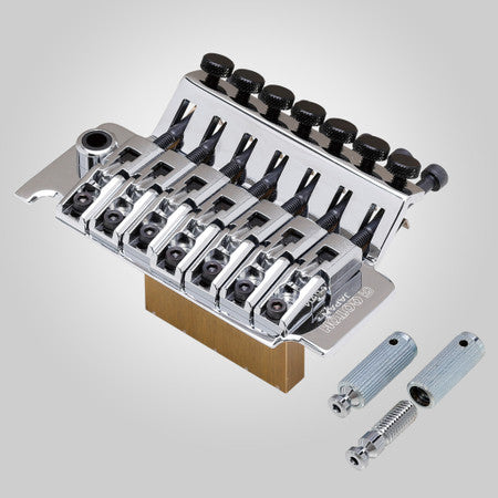 Silver metal locking tremolo bridge with seven tuning knobs plus two thumbwheels and two screws on a gray background.