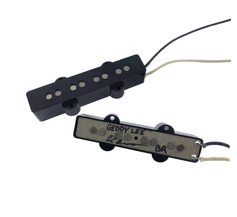 Two black 4-string bass guitar pickups with wiring and 'GEDDY LEE' handwritten on one pickup baseplate.