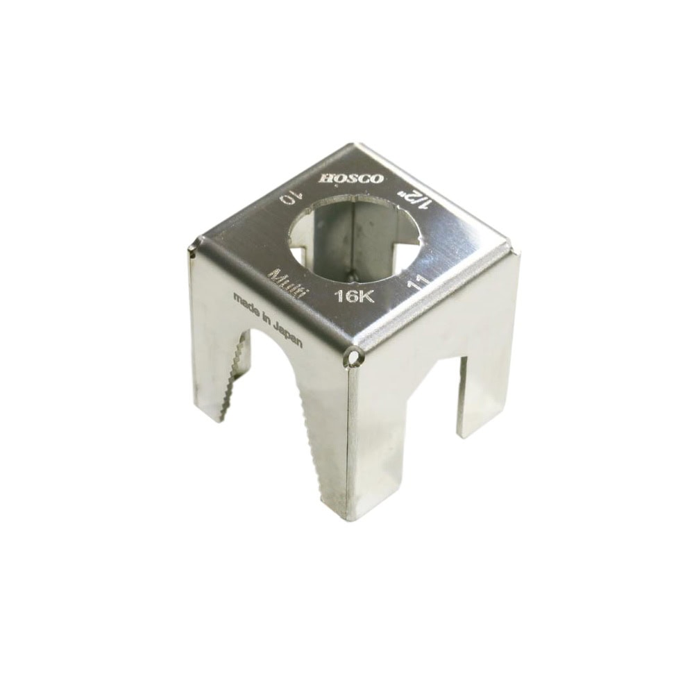 Silver metal cube with various circular cutouts and markings, labeled Hosco and made in Japan.