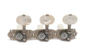 Set of three classical guitar machine heads with white tuning knobs and engraved metal baseplate.