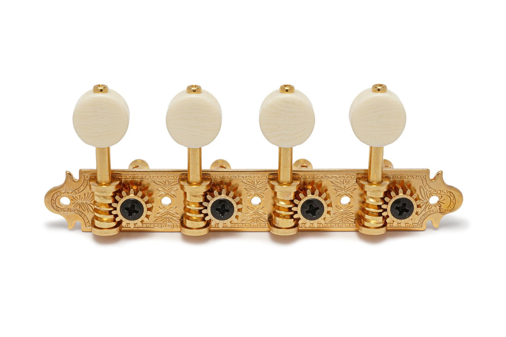Set of four gold metal mandolin machine heads with cream tuning peg knobs mounted on an engraved plate.