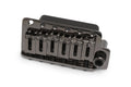 Black metal guitar bridge with six adjustable saddles and mounting holes on a white background.