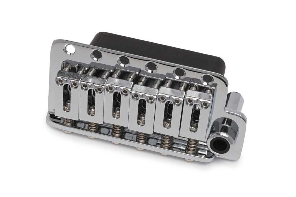 Chrome metal guitar tremolo bridge with six steel saddles and mounting holes on a white background.