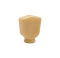 Ivory-colored plastic keystone-shaped button with a round base control knob.