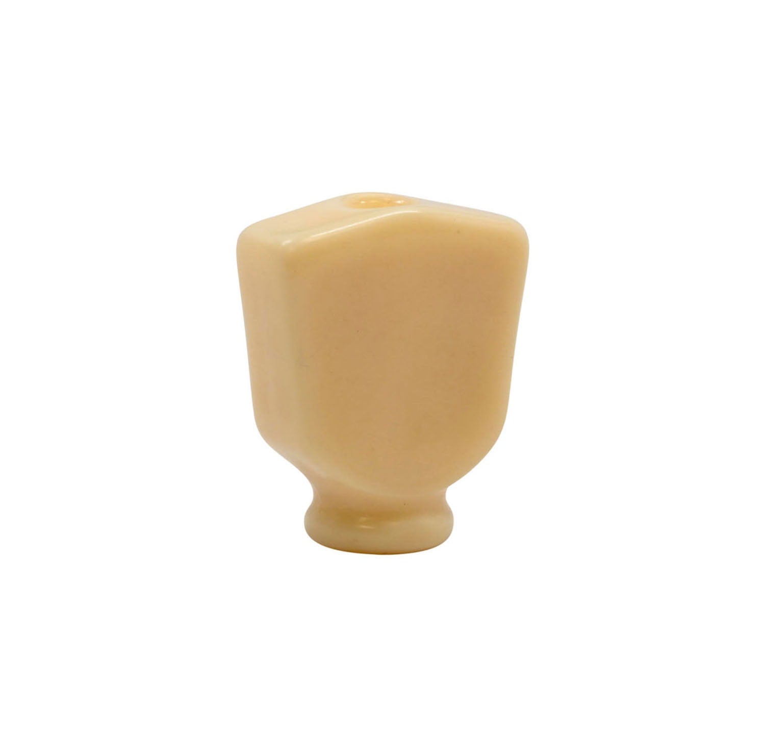Ivory-colored plastic keystone-shaped button with a round base control knob.