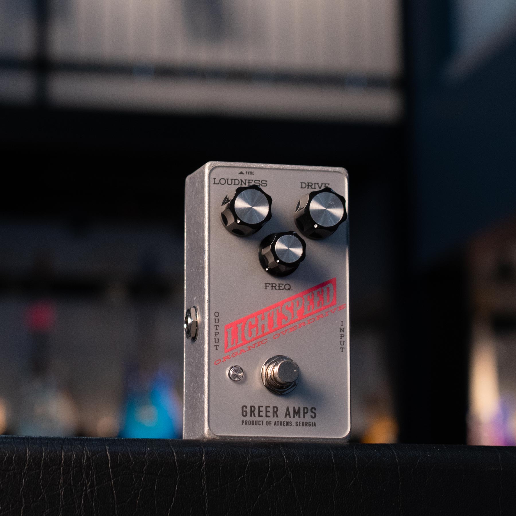Silver guitar effects pedal with three knobs, a footswitch, and red 'LIGHTSPEED' text on the front.