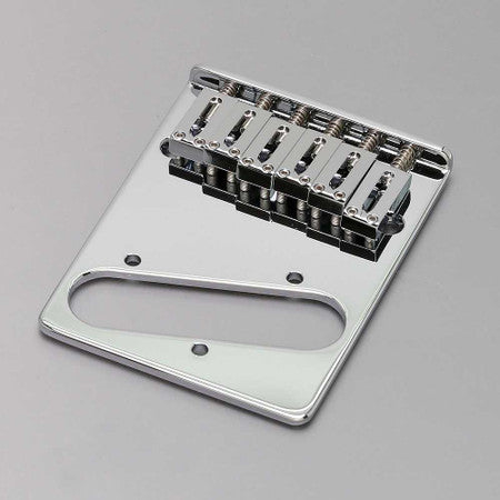 Chrome-finished guitar bridge plate with six adjustable saddles and three mounting holes on a gray background.