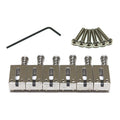 Set of six silver metal guitar saddles with screws and a black hex key on a white background.