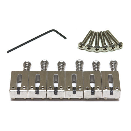 Set of six silver metal guitar saddles with screws and a black hex key on a white background.