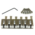 Set of six metal guitar saddles with six screws and one black Allen wrench on white background.