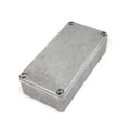 Rectangular gray metal enclosure box with four screws on top corners on white background