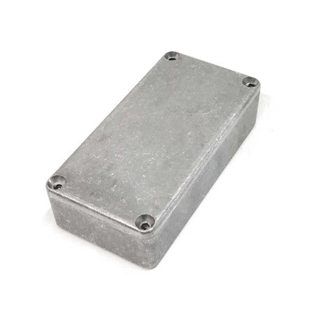 Rectangular gray metal enclosure box with four screws on top corners on white background