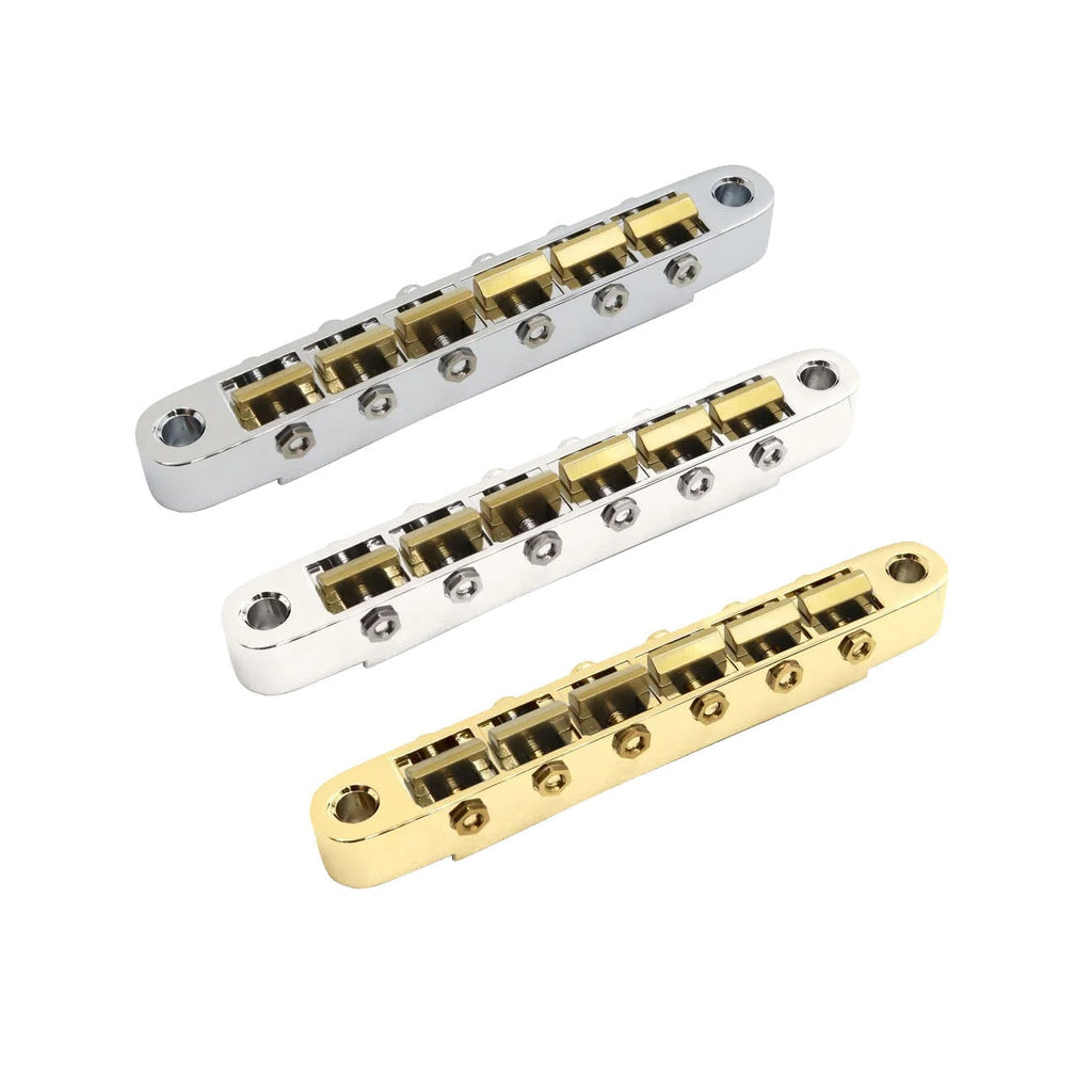 Three metal guitar bridges with brass saddles in gold and silver finishes shown on white background.