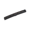 Black slotted nut for an electric guitar with six string slots.