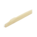 Off-white shaped guitar saddle viewed at an angle on a white background.