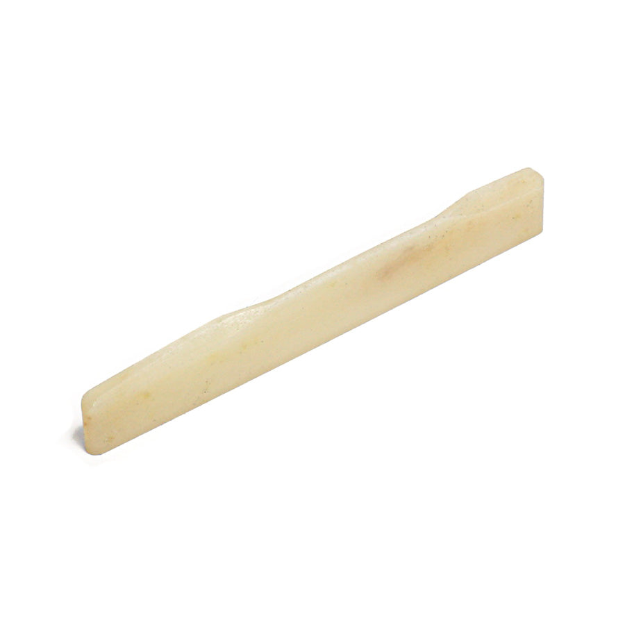 Off-white shaped guitar saddle part viewed at an angled perspective on a white background.