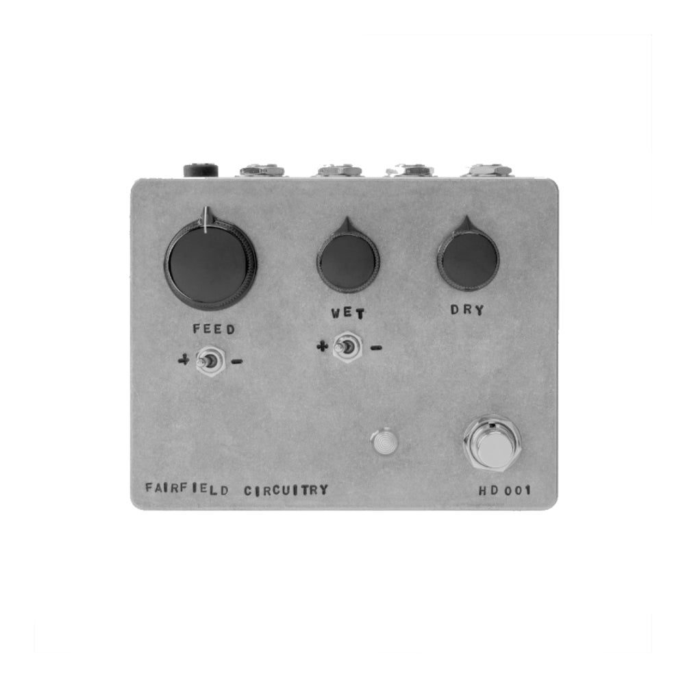 Gray rectangular audio effects pedal with three knobs, two toggle switches, one footswitch, and four jacks on top.