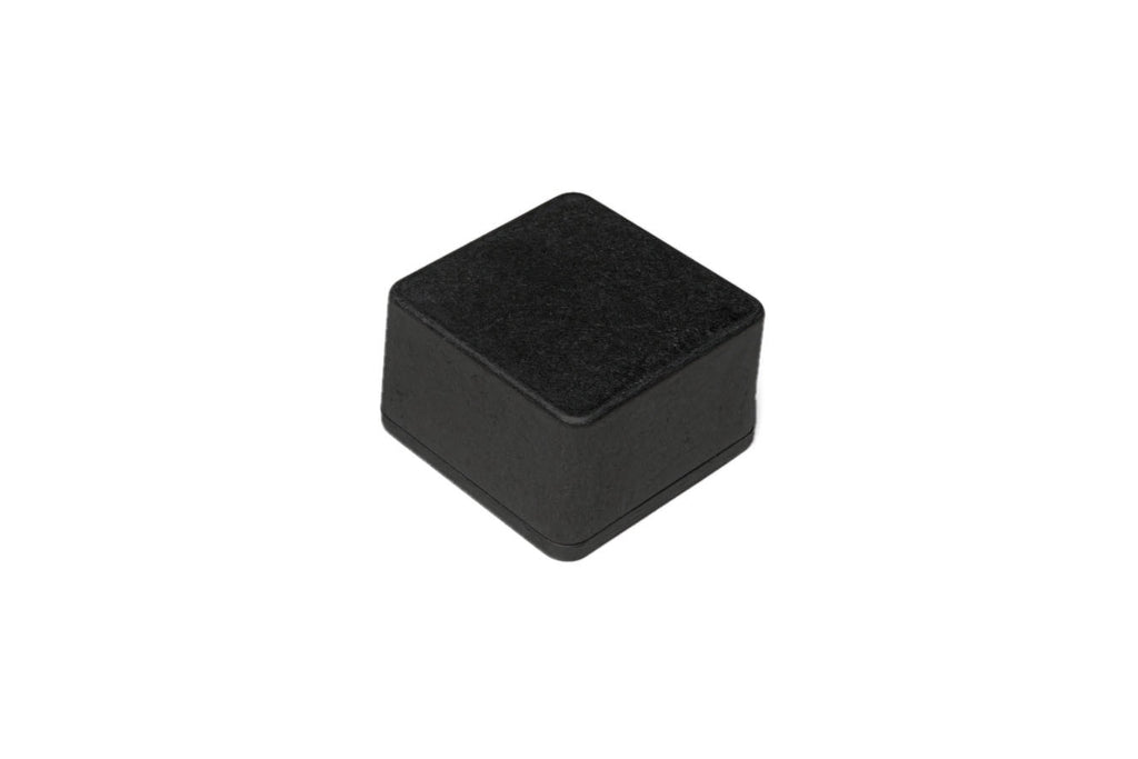 Small black square metal enclosure with rounded edges shown on a white background.