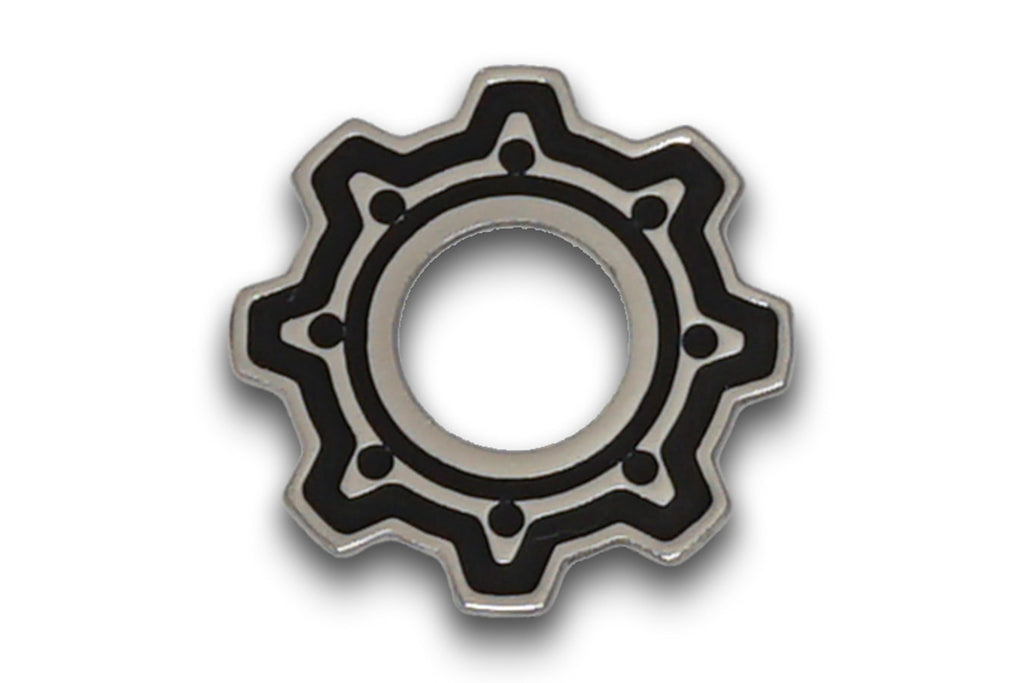 Silver metal gear-shaped washer with black detailing and central hole on a white background