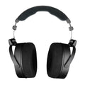 Black over-ear headphones with large padded ear cups and a cushioned headband shown from the front