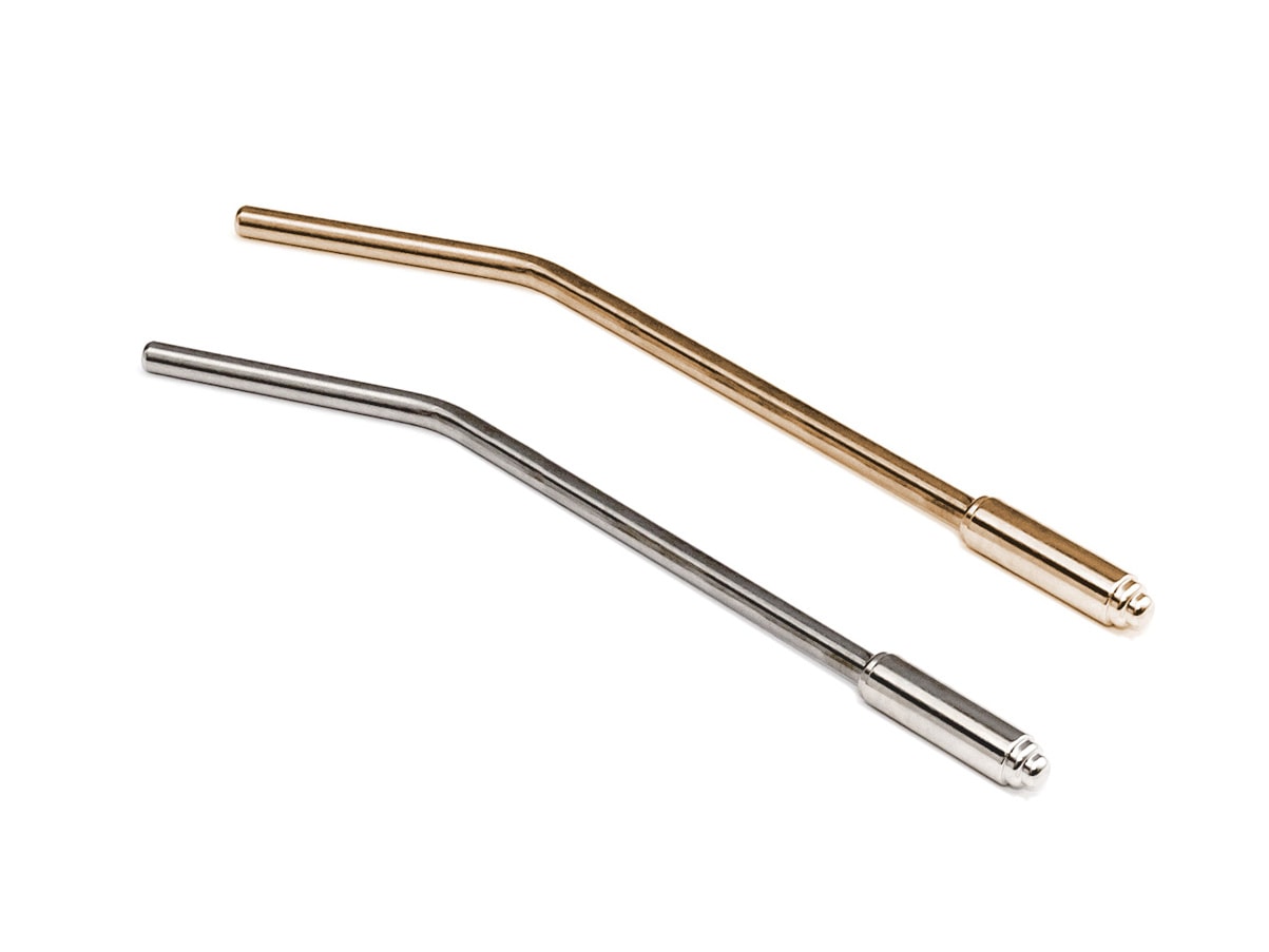 Two metal tremolo arms for guitars, one gold-colored and one silver-colored, photographed on a white background.