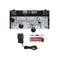 Breadboard with assembled electronic circuit, three knobs, toggle switch, input/output jacks, power adapter, and resistor code guide.