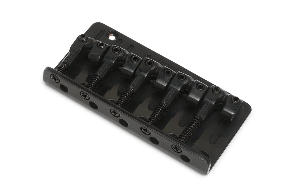 Black metal 5-saddle bridge for a stringed instrument shown on a white background.