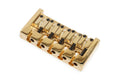 Gold metal 5-string guitar bridge with black adjustment screws and Ibanez engraving.