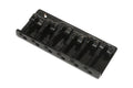 A black metal bridge with six adjustable saddles for strings, likely for a bass guitar.