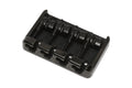 Black metal guitar bridge with four adjustable saddles on a white background.