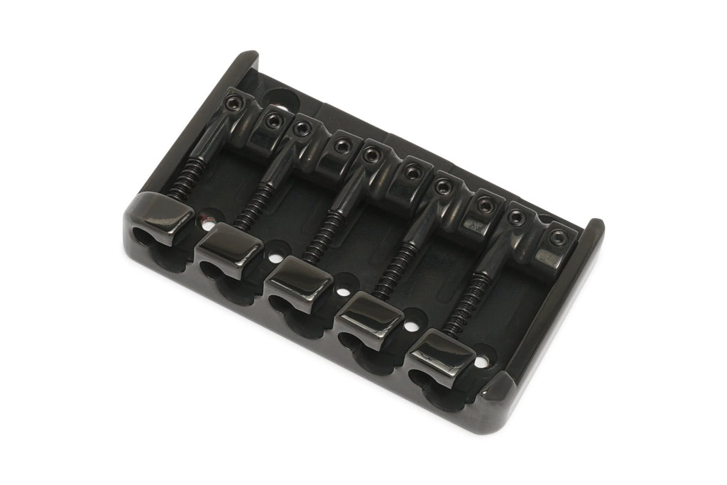 Black metal bridge with five saddles for stringed instrument on a white background.