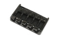 Black metal bridge with five saddles for stringed instrument on a white background.