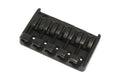 Black metal bridge for a 5-string bass guitar with individual string saddles and adjustment screws.