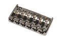 Metallic black and silver 6-string bass bridge with individual string saddles and adjustment screws.