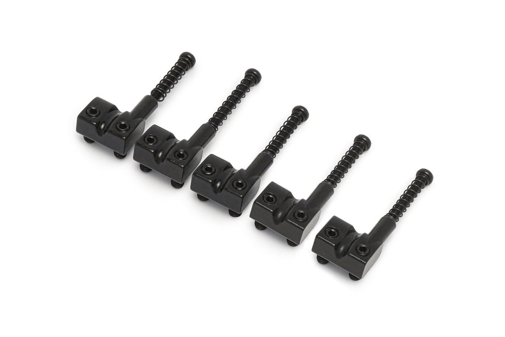 Five black metal bass saddles with adjustment screws arranged in a row on a white background.
