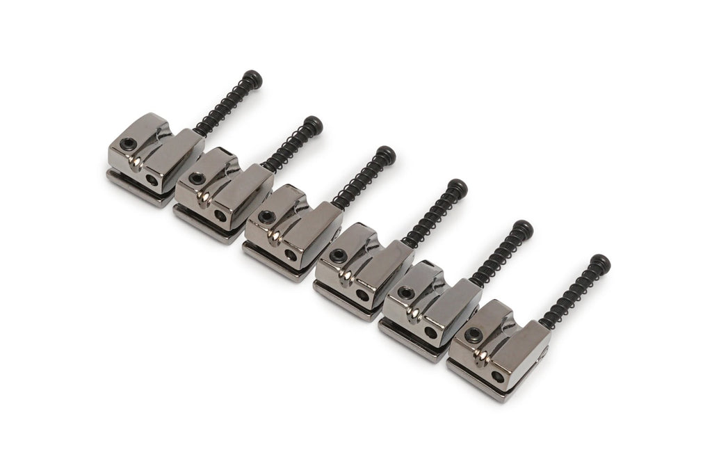 Six metallic gray bass saddles with black adjustment screws arranged in a row on a white background.