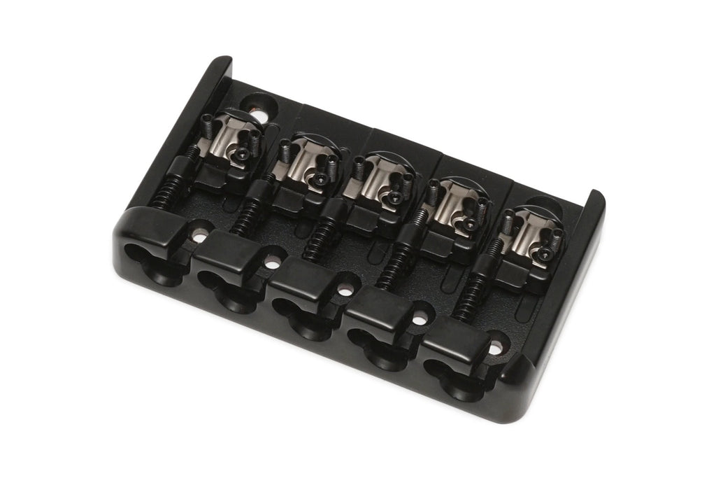 Black metal bridge for a five-string bass guitar with individual string saddles and adjustment screws.