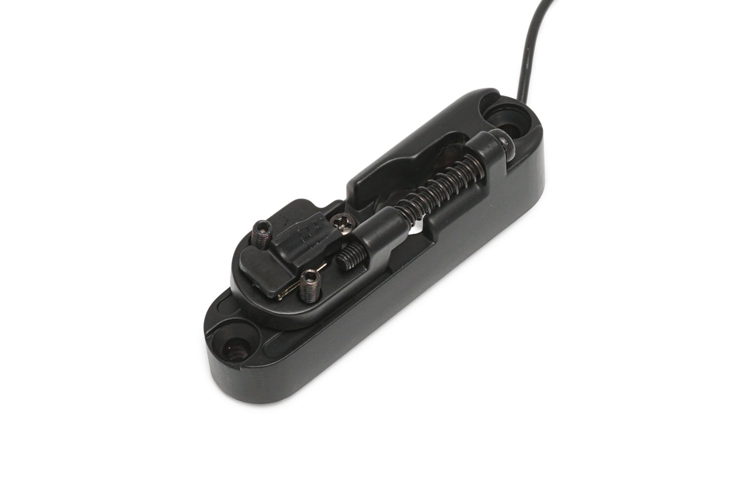 Black single string bridge for bass guitar with attached cable and adjustable components.