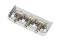 Chrome metal guitar bridge component with four adjustable saddles and mounting holes.