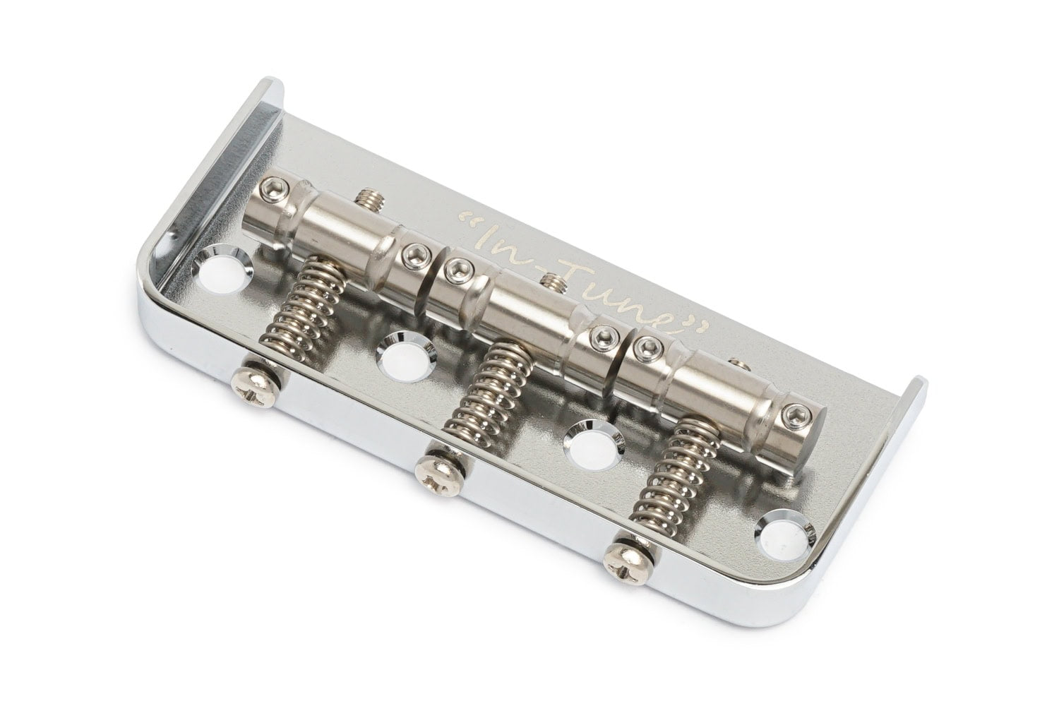 Chrome metal guitar bridge component with four adjustable saddles and mounting holes.