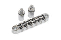 Chrome metal guitar bridge with two cylindrical mounting posts on a white background.