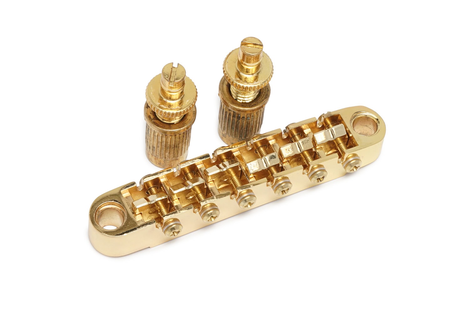 Gold tune-o-matic style guitar bridge with two thumbwheels on a white background