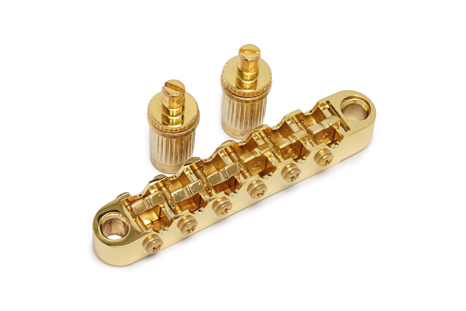 Gold-colored metal guitar bridge piece with two separate gold posts on white background