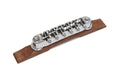 Chrome guitar bridge mounted on a wooden base piece shown on a white background.