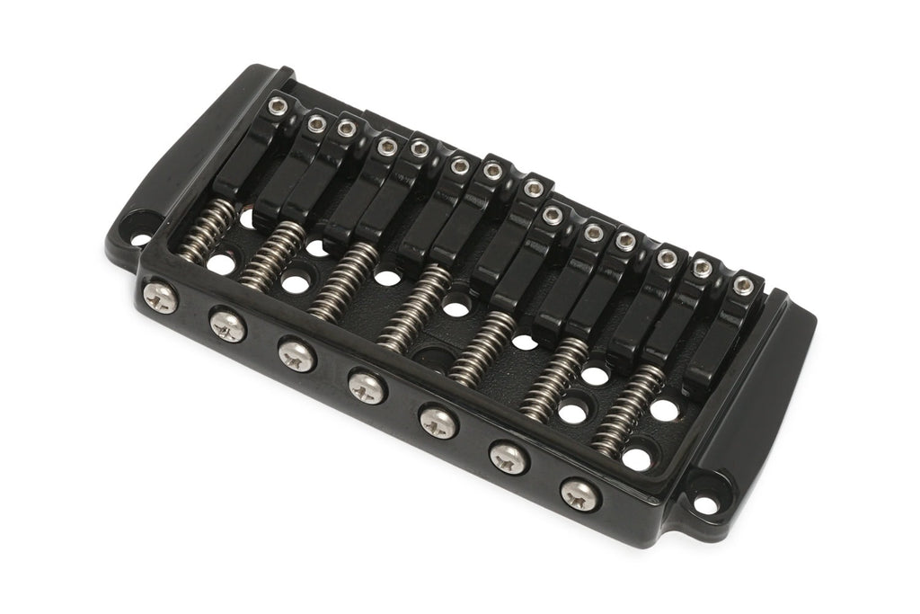 Black metal fixed guitar bridge with seven string saddles and mounting holes on a white background.